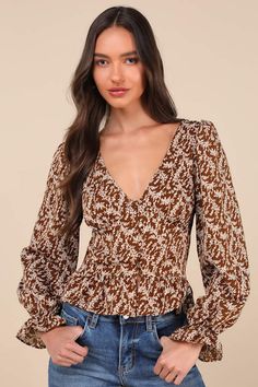 You'll have them falling for you left and right in the darling look of the Lulus Autumn Blossom Brown Floral Button-Front Long Sleeve Top! Lightweight woven fabric, with a vintage-inspired floral print throughout, shapes long balloon sleeves with elastic at the cuffs, ruffled trim, and gathered shoulders. Bodice has lightly gathered cups, a loop-button placket, and a set-in waist. Ruffled trim completes the look. Fit: This garment fits true to size. Length: Size medium measures 21.5" from should Elegant Brown Tops With Floral Print, Elegant Brown Floral Print Top, Blouse With Ruffles, Brown Floral Print, Long Sleeve Floral Top, Long Balloons, You Left, Brown Floral, Ruffle Top