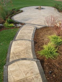 a stone path in the middle of a garden