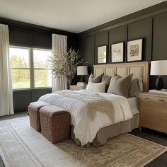 a large bed sitting in the middle of a bedroom next to two lamps on either side of it