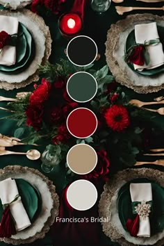 the table is set with red flowers and white napkins, silverware and candles