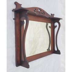 an old mirror hanging on the side of a wall