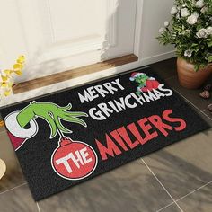 a door mat that says merry grinmas the millers on it and an image of a green lizard