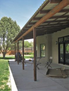 an outdoor covered patio with chairs and tables