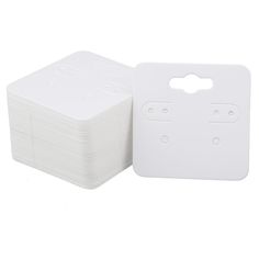 a stack of white paper sitting next to each other on top of a white surface