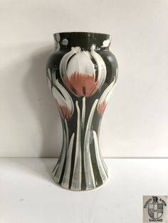 a black and white vase sitting on top of a table