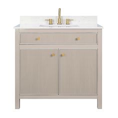 a bathroom vanity with two gold faucets on the top and one white sink