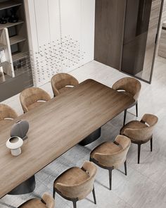 a large wooden table with six chairs around it in a modern dining room setting that has white walls and wood flooring