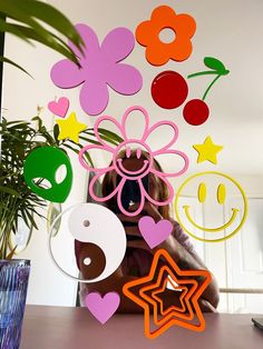 a woman sitting in front of a table with paper cut outs and flowers on it