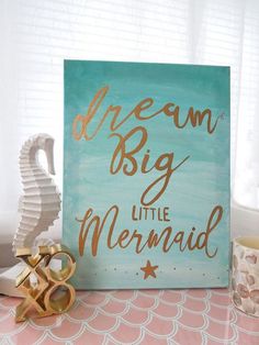 there is a sign that says dream big little mermaid