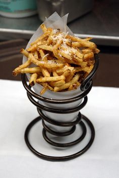 french fries sitting in a bowl on top of a table