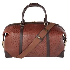 Built with Lucchese’s own Full Quill Ostrich leather, this signature duffle totes your essentials in first class style. The fold-end construction allows for maximum packing space, which includes natural, water-resistant canvas lining, an interior zipper pocket and two open storage slots. Luxury Leather-backed Tote Travel Bag, Luxury Weekender Bag With Leather Lining And Double Handle, Luxury Brown Duffle Bag With Leather Trim, Luxury Leather-backed Tote Weekender Bag, Luxury Cognac Weekender Bag With Leather Handles, Luxury Weekender Bag With Leather Backing, Luxury Cognac Bags For Overnight Trips, Luxury Textured Leather Rectangular Weekender Bag, Luxury Rectangular Textured Leather Weekender Bag