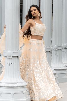 Beat the heat with this sparkly peach lengha set which has stolen its grace straight from the dawn of a steamy summer morning. -Highly flared and light georgette lengha skirt with elaborate foil work - Summer friendly strap blouse with patterned foil embroidery - Plain ruffled dupatta for a lavish finish #foilworklehenga #foilworkembroidery #silverfoilworklehenga #summerlehenga #summerlehengadesigns #peachlehenga #monochromelehenga #strapblouse #spaghettiblouse #strapblouselehenga Summer Lengha, Peach Lengha, Georgette Lengha, Lengha Skirt, Desi Wardrobe, Peach Lehenga, Peach Gown, Strap Blouse, Crop Top Lehenga