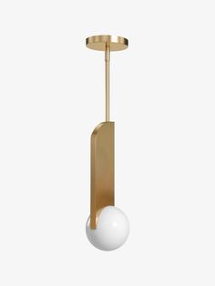 a white ball is hanging from a brass plated light fixture with a round base