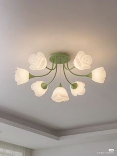 a ceiling light with white flowers on it