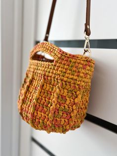 Crochet basket bag is made from a high quality solid chunky yarn It will be great for everyday use.  Color is amazing : all fall colors in one. orange, green, yellow and red shades. Easy to take care of: hand wash in a cool water or gentle washing machine cycle. Please reattach all metal and leather details befor washing.  Height 23 cm/9.05 in Width  32cm/12.59 in Ajustable leather handle is 120cm/47.24 in Crochet Basket Bag, Red Shades, Crochet Basket, Basket Bag, Chunky Yarn, Leather Handle, Fall Colors, Ukraine, Accessory Gift