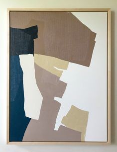 a painting hanging on the wall in front of a white wall with brown and blue paint