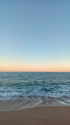 the ocean waves are rolling in to shore