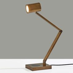 Modern functionality and industrial styling meet in the Newman Desk Lamp. This high end desk lamp has a metal finish and is adjustable at 3 points to direct light exactly where it is needed. A cylinder shade houses an integrated, eco-friendly 10W LED light that is replaceable. With a 4-way touch switch conveniently located on the base, this lamp offers a 3 levels of brightness (low, medium, high), making the perfect lighting available at the touch of a finger. 
For added functionality, the base of the lamp houses an integrated Qi-certified charging pad, supporting 5W charging on contact to get your phone from 0% to 100% in just 3-4 hours. A USB port is also located on the side of the base for charging a second device simultaneously. The lamp is powered by a 5 foot black fabric covered cord Shade House, Career Inspiration, Virtual Staging, Touch Switch, Charging Pad, Metal Lamp, Desk Design, Metal Finishes, Bronze Color