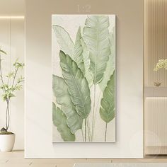 a large green leafy plant is hanging on the wall next to a potted plant