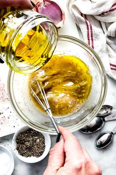 someone is mixing ingredients in a glass bowl