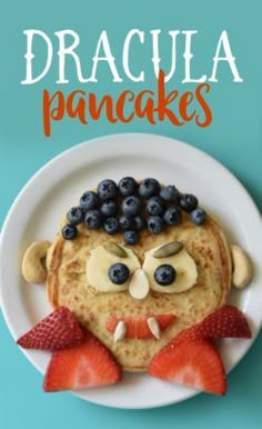 pancakes with fruit on top and face made to look like a man's head