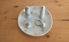 two salt and pepper shakers sitting on a plate