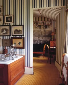 an open door leading to a bathroom with striped walls and flooring on both sides