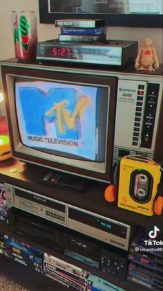 an old television sitting on top of a tv stand