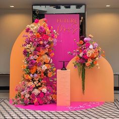 two vases filled with flowers on top of a pink and orange carpeted floor