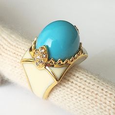 UNIQUE VINTAGE BY CRISTINA SABATINI 18k GOLD PLATED, CZ, RESIN RING SIZE 7 Suppose you are looking for a statement piece of jewelry that combines elegance, color, and sparkle. In that case, you might want to check out the CRISTINA SABATINI 18k Gold plated, CZ, turquoise cabochon resin ring.  This ring is a stunning creation by Cristina Sabatini, a designer known for her gold-plated, precious stone, and sterling silver creations. The ring features a large turquoise-like resin cabochon, and cubic Gold Luxury Enamel Ring With Cabochon, Gold Luxury Enamel Cabochon Ring, Elegant Gold Turquoise Cabochon Ring, Oval Cabochon Enamel Ring Collectible, Elegant Collectible Cabochon Turquoise Ring, Vintage Turquoise Enamel Jewelry, Luxury Gift Enamel Ring With Cabochon, Luxury White Oval Enamel Ring, Vintage Enamel Cabochon Rings