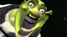 an animated green creature with big eyes and large fangs on it's face, standing in the grass