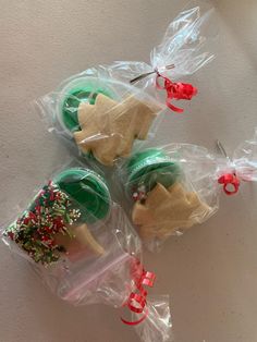 three plastic bags filled with cookies on top of a table