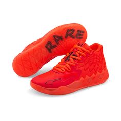 a pair of red shoes with black lettering on the side and an orange shoelace