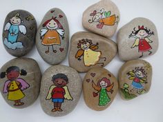 some rocks with pictures of children painted on them