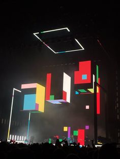 the stage is lit up with colored squares