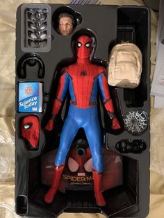 spider - man action figure with accessories in its package on a bed, ready to be played