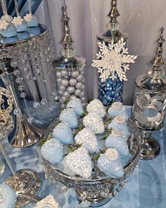 blue and silver decorations are displayed on a table