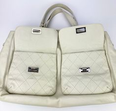 Chanel White Caviar Pocket in the City Large Tote in very good condition. Cream white glazed caviar exterior trimmed with silver hardware and two front flap pockets with mademoiselle twist locks. Top snap closure opens to a gray satin lined interior with ample storage space, one zipped side pocket and a leather key strap. Overall very good condition. Clean corners and edges. A few make up marks and scuffs throughout interior. see photos. Top handles can turn into shoulder straps. Purchase includ Tote Chanel, Chanel White, Chanel Tote, Exterior Trim, Leather Key, Dust Cover, Large Tote, Side Pocket, Silver Hardware