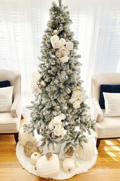 a christmas tree with white and silver decorations