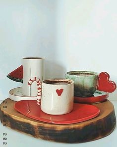 two mugs are sitting on a tray with candy canes