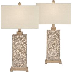 a pair of table lamps sitting next to each other on top of a white floor