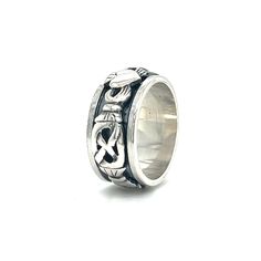 Introducing our grand Claddagh Spin Ring, a true masterpiece of both size and sentiment that stands as a bold statement piece with a robust and masculine design. This ring's substantial presence, intricate details, and powerful symbolism make it a captivating addition to your collection, embodying the enduring essence of the Claddagh and the functionality of a spinner ring. This design transcends mere adornment, encapsulating the enduring virtues of love, loyalty, and friendship. The heart, gent Symbolic Engraved Wide Band Ring, Symbolic Wide Band Engraved Rings, Symbolic Engraved Ring With Oxidized Finish For Promises, Symbolic Oxidized Finish Skull Ring, Symbolic Oxidized Finish Promise Ring, Spin Ring, Masculine Design, Spinning Rings, Ring Sale