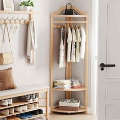 a coat rack with shoes and other items on it next to a door in a room