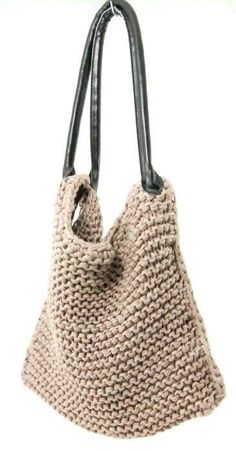 a crocheted handbag with black handles is shown in front of a white background