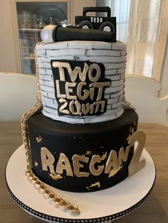 a black and white cake with two legos on top