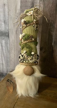 an odd looking stuffed animal sitting on top of a wooden table