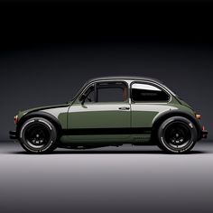 an old green car parked in a dark room