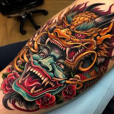 a dragon tattoo on the arm and shoulder