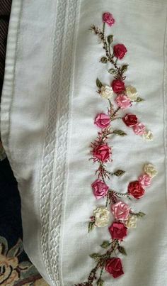 a white bag with pink and red flowers on it