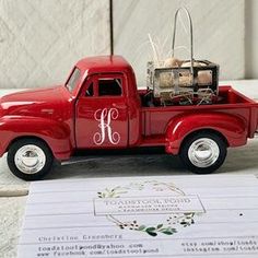 a red truck with a monogrammed letter on the back